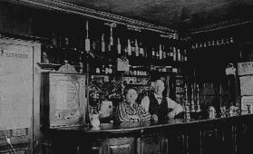 Wm & Amy Bower behind bar